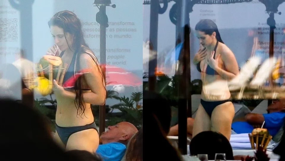 De biquíni, Rosalía toma água de coco ao curtir piscina de hotel no Rio
